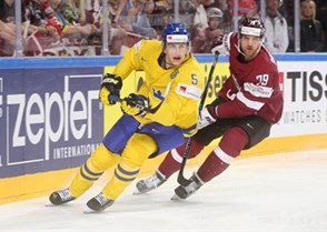 COLOGNE, GERMANY - MAY 11: Sweden's Philip Holm #5 and  Latvia's Vitalijs Pavlovs #79 skate during preliminary round action at the 2017 IIHF Ice Hockey World Championship. (Photo by Andre Ringuette/HHOF-IIHF Images)

