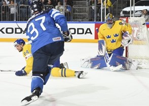 COLOGNE, GERMANY - MAY 20: Sweden's Henrik Lundqvist #35 makes a save against Finland's Mika Pyorala #37 while his teammate Alexander Edler #24 looks on during semifinal round action at the 2017 IIHF Ice Hockey World Championship. (Photo by Matt Zambonin/HHOF-IIHF Images)

