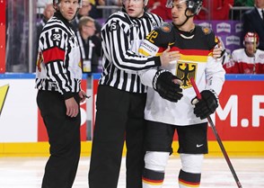 COLOGNE, GERMANY - MAY 12: Linesman Gleb Lazarev holds back Germany's Yasin Ehliz #42 while referee Marcus Linde looks on during preliminary round action against Denmark at the 2017 IIHF Ice Hockey World Championship. (Photo by Andre Ringuette/HHOF-IIHF Images)

